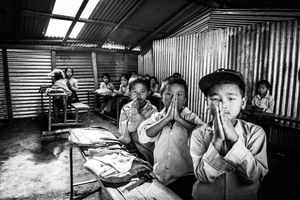 Pupils in a school in Mandre, Gorkha District. On 25 April 2015, the school was completely destroyed by the earthquake. It was only after 4 months that the residents managed to rebuild a temporary school, using corrugated iron. 250 pupils attend this school. They are taught in poor conditions, without electricity and school materials.