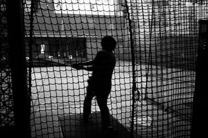 A guy play baseball in batting center in Shinjuku