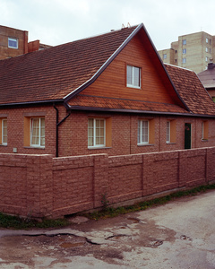 Red brick single family house and red brick wall close to the river Nemunas, Kaunas, Lithuania, September 2015.