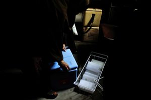 A vaccinator collects vaccine from a cold chain in Bhiwandi, Maharashtra