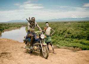 Oyta, his boy, and the village motorbike. Kara tribe, Southern Ethiopia.