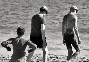 Tourists covered in thermal mud