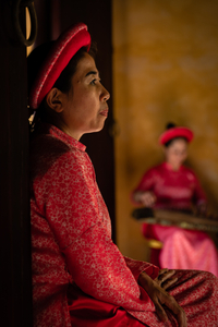 Woman in traditional Vietnamese clothes in Hue Imperial Citadel.