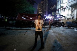 A young protester stands in front a makeshift barricade during a peaceful demonstration near Taksim Gezi park in Istanbul, Turkey on Wednesday 12th, 2013.