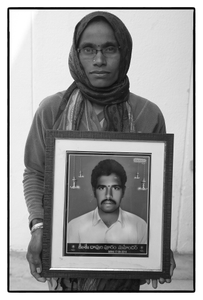 Madhavi with photo of her husband D. Mahendar – a debt stressed farmer, who committed suicide. Telengana, India.