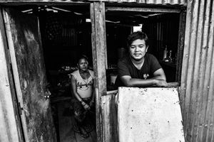 A family living in a temporary shelter in the village of Baluwa, in Gorkha District.