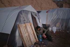 A kurdish man while making a lamp which word with oil ready for warming up the tent