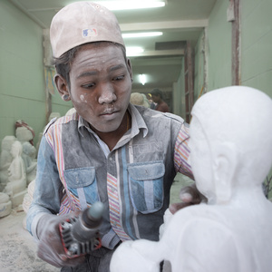 Child labourer grinds a statue of Buddha in Mandalay, Myanmar.