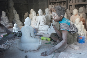 Dust covered child labourer at workshop in Mandalay, Myanmar.