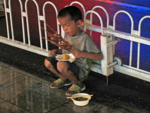 Street boy eating