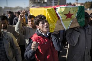 People carry coffins of People's Protection Units (YPG) fighter killed during fighting with Islamic State forces in the Syrian town of Kobane, during a funeral in Suruc, near the Turkey-Syria border, November 6, 2014.