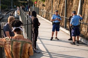 With a group of friends being stopped and questioned by police officers at a Light Rail station.