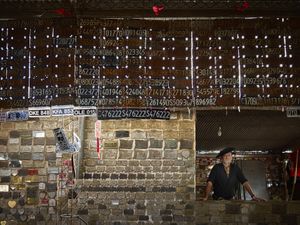 Ex votos and car plates as applications for protection while driving, exhibited in the main temple of Gauchito Gil in Mercedes town, Corrientes