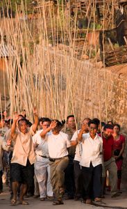 A procession of Dai rocketeers dances its way through Meng Ben’s main street up to a nearby hill where the rockets will be launched. at the start of the picking season on Jingmaishan © Michael Freeman