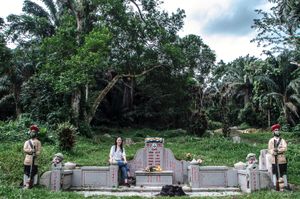 Cecilia Chong vising her great grandfather's grave," This cemetery brings our family together,what happens?When this is destroyed to build new roads and flats to house the new population?"© Amrita Chandradas