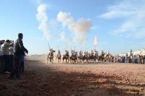 Gunpowder smoke and muzzle blasts as the sorba ( riding team) end its charge.  Seffrou, Morocco