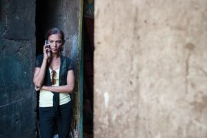 Urmi makes a call outside one of The Humsafar trust's community offices.  © Alison McCauley