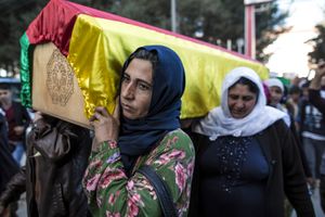 Kurdish women carry a coffin containing the body of a female fighter of the Kurdish Women's Protection Unit (YPJ) in Suruc, Turkish southeastern Sanliurfa province, on November 7, 2014.