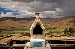This large chorten or incense burner is on the roof of Mindroling Monastery near Dranang, Tibet. It was photographed on 1 July 2005. © Forest McMullin