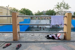 Clothes, sandals and towels beside the pool
