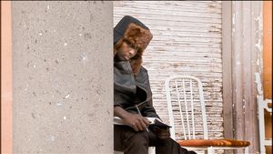 Rome, Italy (2010).  The Somali Embassy. Young migrant, idle, with notebook and pen.