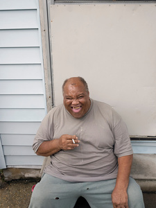 USA. New Orleans. 2015. Portrait of a man in the front yard of his apartment.