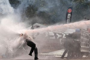 A protester is hit by a water cannon from a police TOMA vehicle during clashes in Taksim square in Istanbul, Turkey on Tuesday, June 11, 2013.