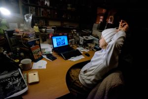 The owner of Bhaktivedanta Library Services watches the festival kirtans by livestream in her office