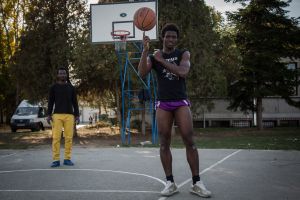 Somali refugee portrait on a basketball court in refugee camp in Obrenovac. Refugees spend a lot of time on playground, they want their time in the camp to be spent faster, and at the same time it is fun for them. Currently in this camp there are about 890 refugees who are stuck here in Serbia. October 2017.
