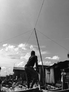 Boy rows canoe in Makoko
