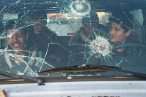 Refugees are having fun in an abandoned car,