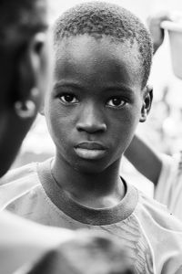 La fête du village - boys in trees and girls in the crowd,  waiting for the spectacle to begin in a little village in Burkina Faso.