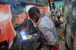 In the Enlight garage in the Buru Buru Phase 1 district of Nairobi, a welder improves the exterior of an older Matatus, which gets newly prepped up and sprayed with graffitis. The cost of pimping an old bus can be up to 1.5 million Kenyan Shillings, around 15,000 US Dollars.
