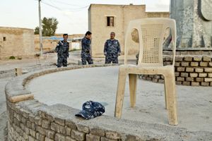 Three policemen of the Kurdish police force are having a break while guarding the citadel in Erbil. © Tom Verbruggen