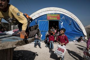 Syrian Kurdish children from Kobani exit from an improvised classroom in 'Kobani' refugee camp in the border town of Suruc, Sanliurfa province, Turkey on November 10, 2014.