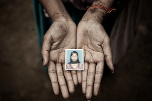 Chanchal Paswan holds the only passport photograph she has of herself from before the acid attack.