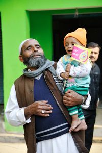 A father brings his son to the Polio Booth in Moradabad, Uttar Pradesh
