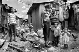 © Tony Corocher - This family is made up of 3 women (mother and 2 sisters)… the father disappeared a long time ago. These women take care not only of their own children (which are a few as you can see) but have also started a project to try to rescue the so called "Street Children" (see second photo in the series). These children sniff glue, oil and solvents and eat from the streets. The 3 women p