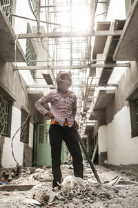 Kan Ton 30, pauses for a second from cleaning rubble from a construction site in central Phnom Penh.