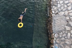 Kid plays in the pool