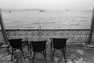 Wicker chairs on a veranda overlooking the Bosphorus.