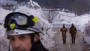Farindola, Italy (2017). Avalanche Hotel. Rescuers, a fireman and two soldiers, walk away from the Rigopiano hotel, on the day the last bodies were recovered. The remains of the luxury resort are visible behind them, on the top of the frame.