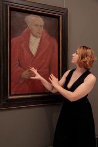 Artist Marina Albu in front of the painting of Olga Greceanu, © National Museum of Art, Bucharest