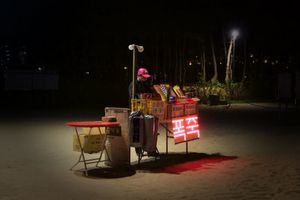 A lady selling fireworks at seaside