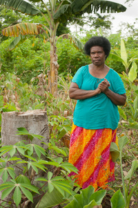 Sarah Toara, 58 years, standing in her garden, Teoma Village, Efate Island.