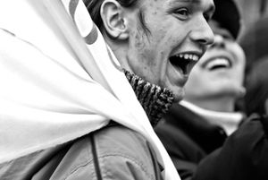Dnipropetrovsk  (Now Dnipro)  Youths in huge street parade carry flags endorssing politicians and political parties during primitive campigning in the early 2000s.   The spectacle demonstration then carried  more weight before politics became more issue oriented.