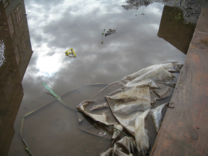 building reflection in puddle and sky