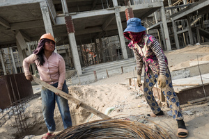 Oung Vanak 45 from Srey Rieng Province and  Thon Chanta 34 from Kampong Speu Province move steel cable used for construction at the end of a days work.