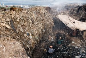 Scavengers of Smokey Mountain dig the landfill for iron, metal scraps and other materials buried under the waste.