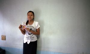 Mandalay, Myanmar, 2013. A young hotel worker displays the 969 sticker that she's been given. © Spike Johnson